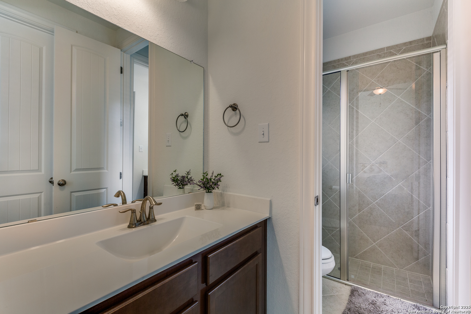 390 Rhapsody View Spring Branch, TX 78070 - Photo 23 of 39 a bathroom with a sink and a mirror