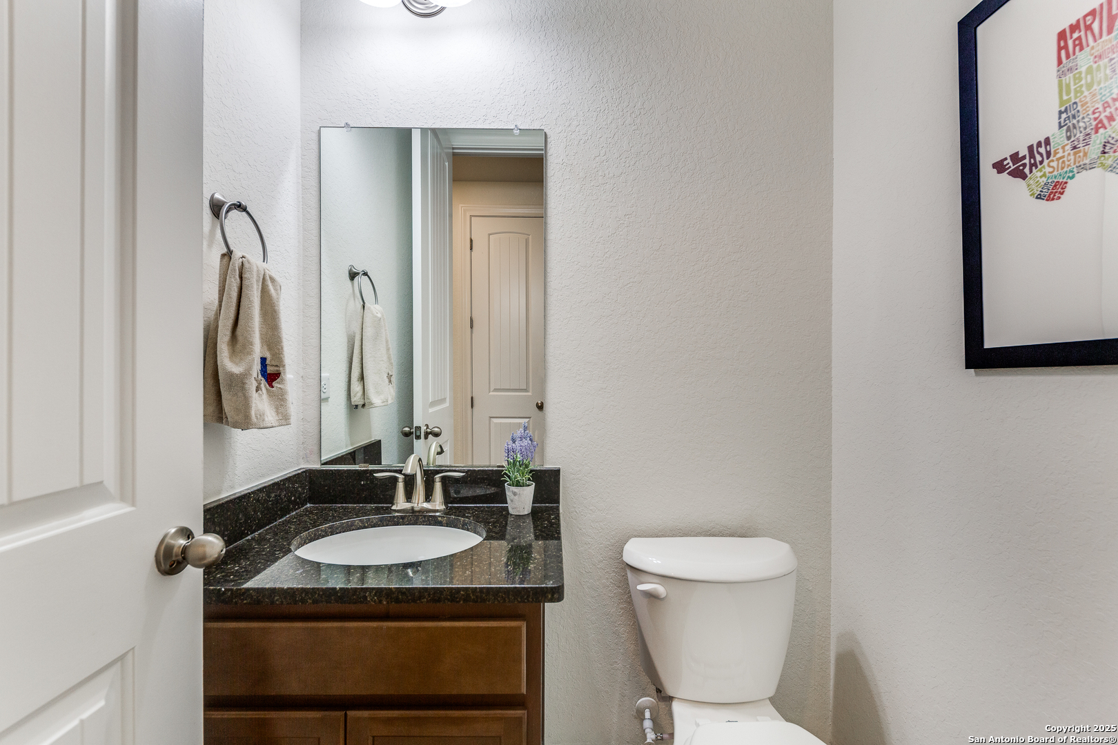 390 Rhapsody View Spring Branch, TX 78070 - Photo 26 of 39 a bathroom with a granite countertop sink and a mirror
