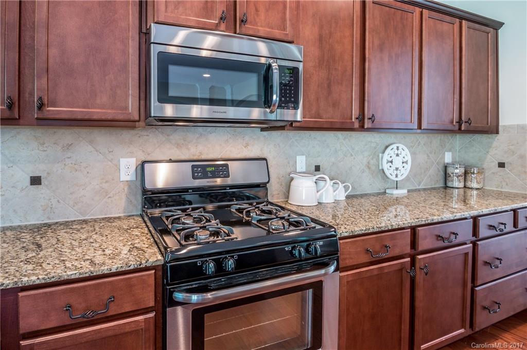 1108 Ridgehaven Road Waxhaw, NC 28173 - Photo 8 of 24 a kitchen with granite countertop stainless steel appliances and wooden cabinets