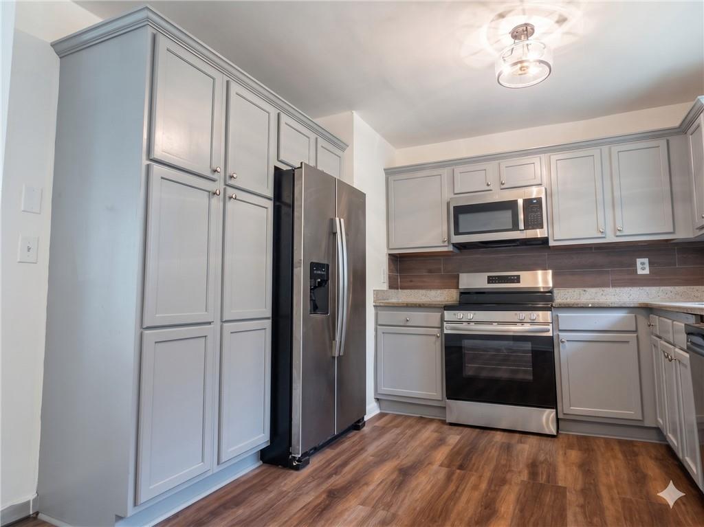 1929 Wee Kirk Road Southeast Atlanta, GA 30316 - Photo 9 of 22 a kitchen with a refrigerator stove and microwave