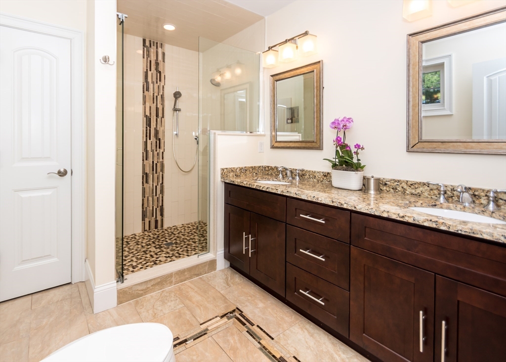 128 Church Street, Unit 2 Waltham, MA 02452 - Photo 25 of 41 a bathroom with a granite countertop sink mirror and shower