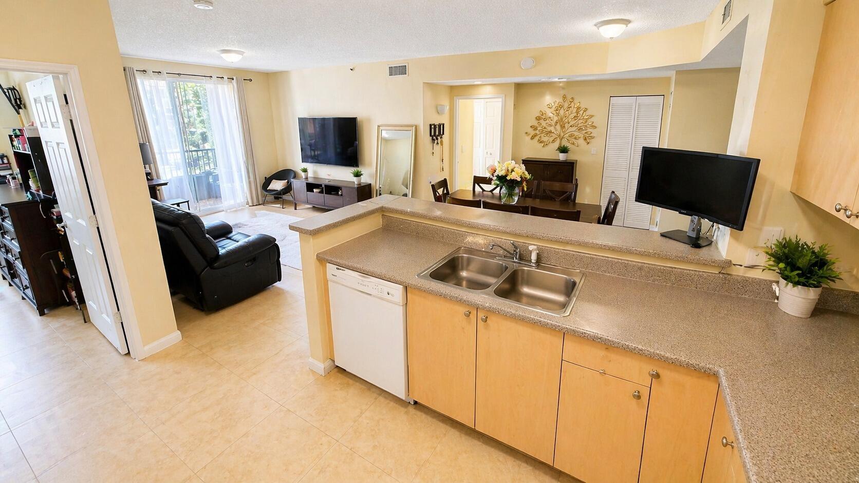 7980 North Nob Hill Road, Unit 205 Tamarac, FL 33321 - Photo 17 of 23 Kitchen-Island-Overlooking-Living-Room