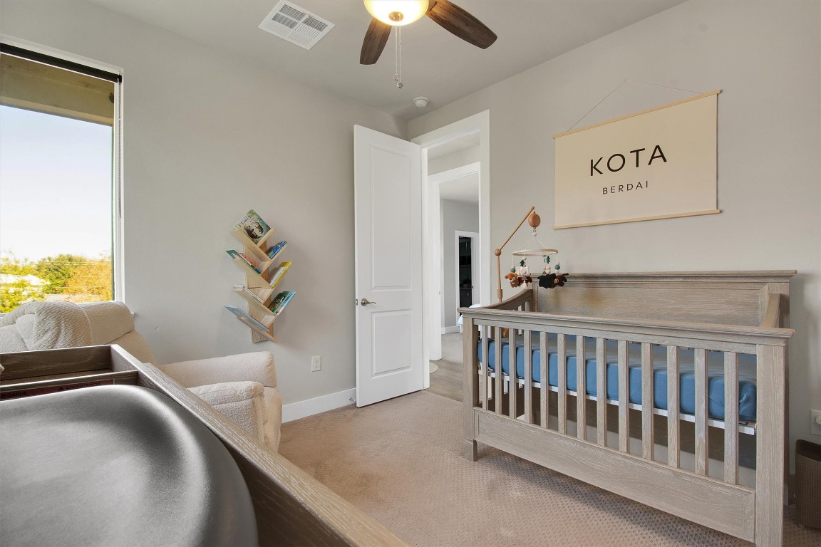 1905 Alegria Road, Unit B Austin, TX 78757 - Photo 20 of 25 Versatile Third Bedroom or Office – Peaceful and light-filled with soft carpet and modern finishes, ideal for use as a nursery, home office, or relaxing guest space.