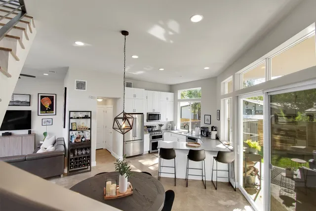 a kitchen with granite countertop a stove top oven sink and cabinets