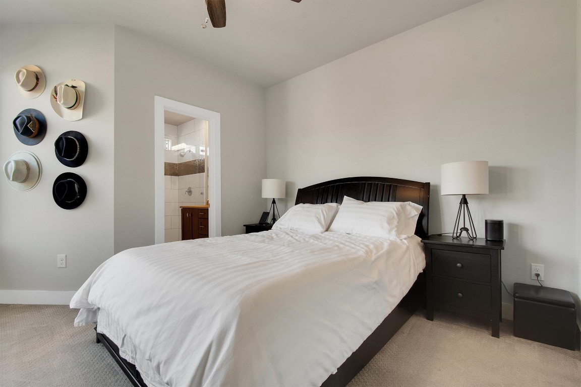 1905 Alegria Road, Unit B Austin, TX 78757 - Photo 4 of 25 Serene Primary Bedroom – Spacious and bright with neutral tones, plush carpet, and a calm, modern feel—your perfect retreat after a long day.