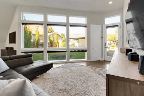 a living room with furniture a dining table and chairs