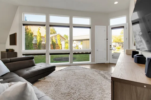 a living room with furniture a dining table and chairs