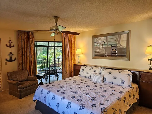 a bedroom with a bed couches and wooden floor