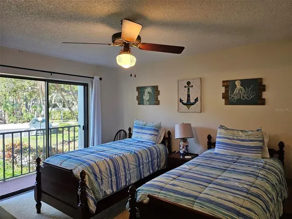 a bedroom with two beds and a large window