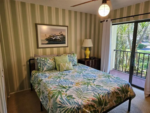 a bedroom with a bed and a painting on the wall