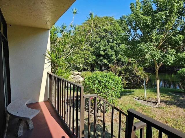 a view of a porch with a table and chairs