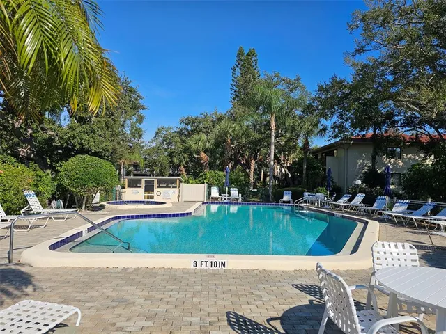 a view of a house with swimming pool and sitting area