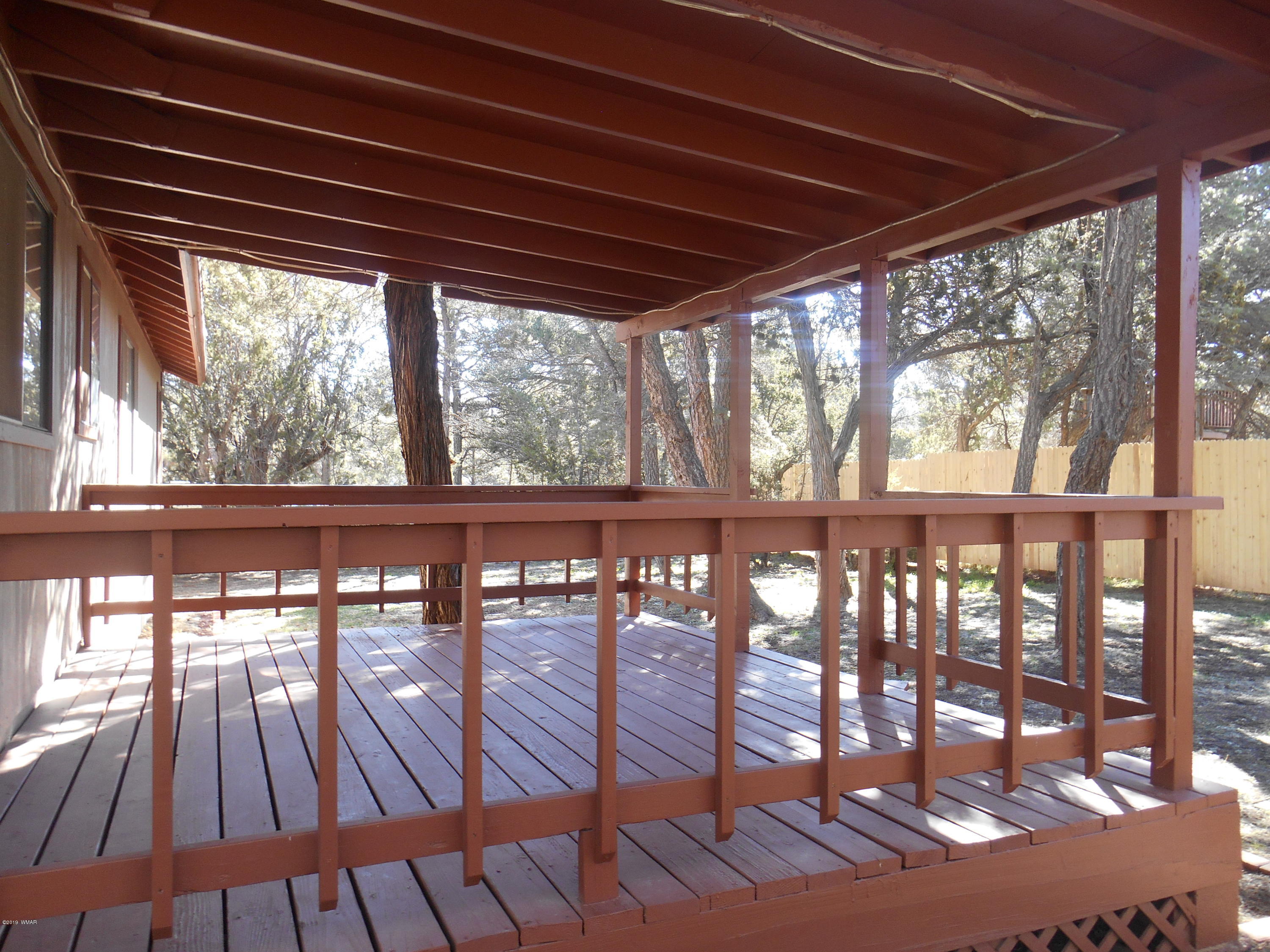 2141 Wildflower Road Overgaard, AZ 85933 - Photo 16 of 21 a view of porch with a table and a chairs