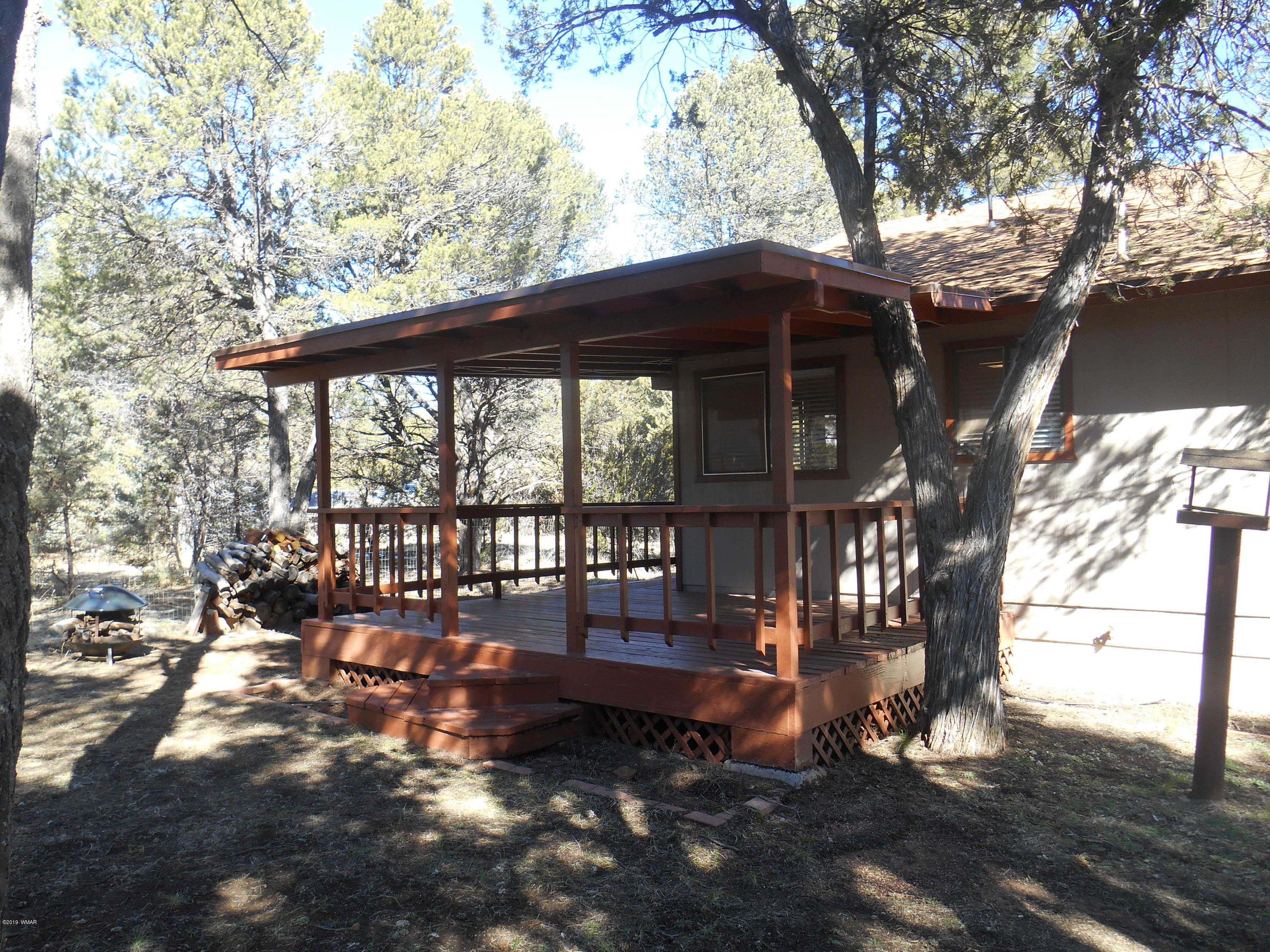 2141 Wildflower Road Overgaard, AZ 85933 - Photo 17 of 21 a backyard of a house with outdoor seating