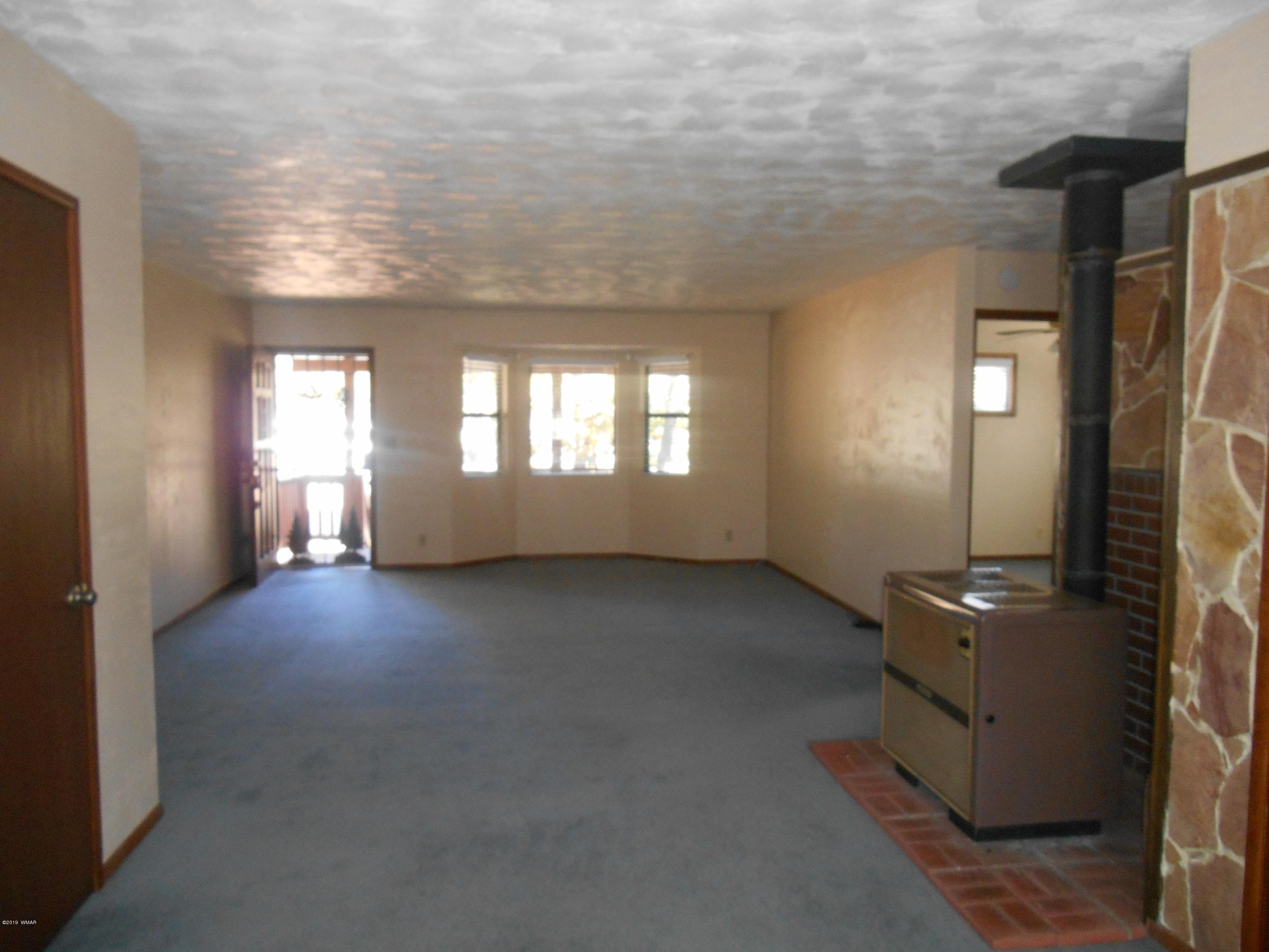 2141 Wildflower Road Overgaard, AZ 85933 - Photo 5 of 21 an empty room with windows