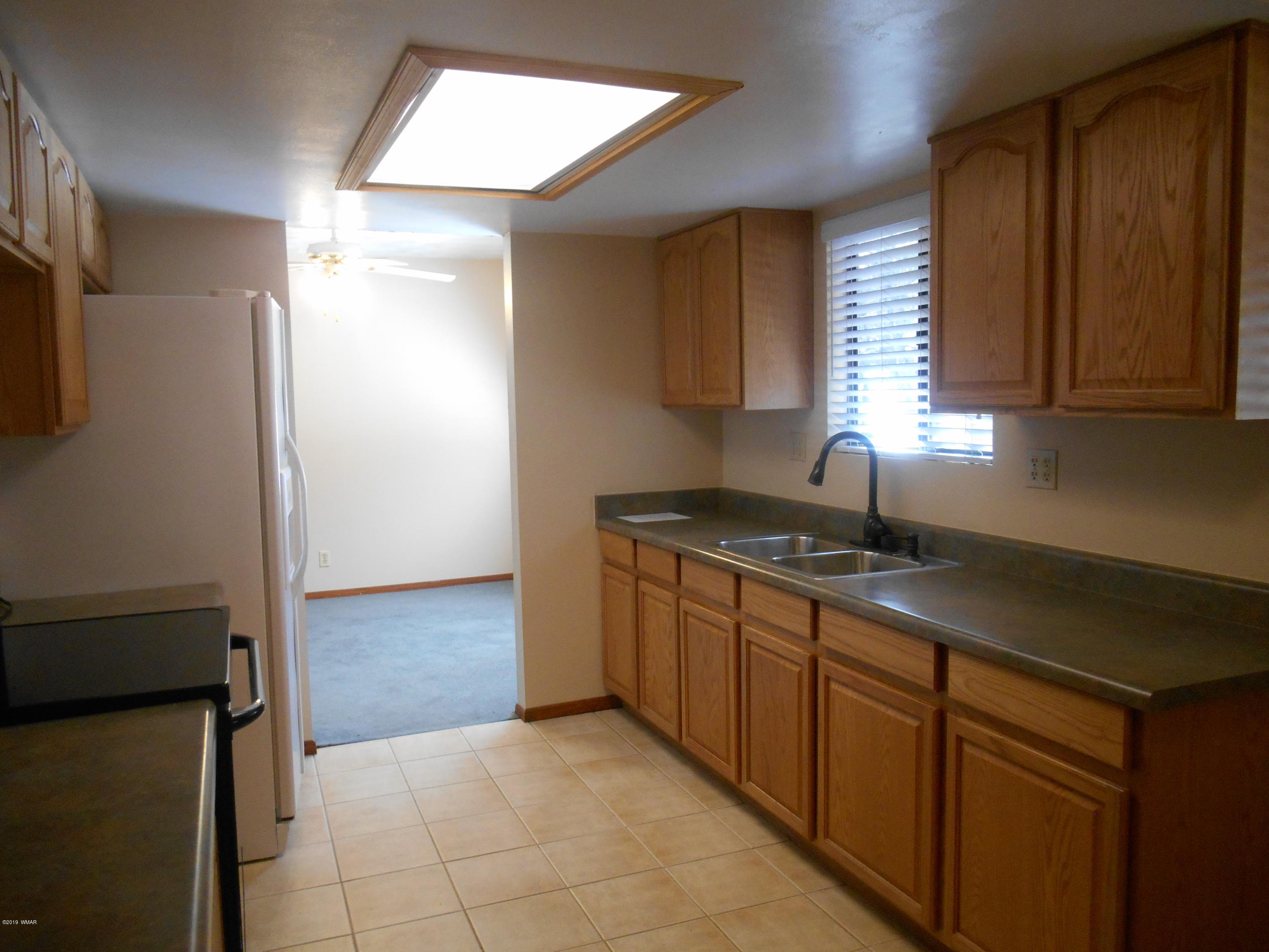 2141 Wildflower Road Overgaard, AZ 85933 - Photo 9 of 21 a kitchen with stainless steel appliances granite countertop a sink and a stove next to a window