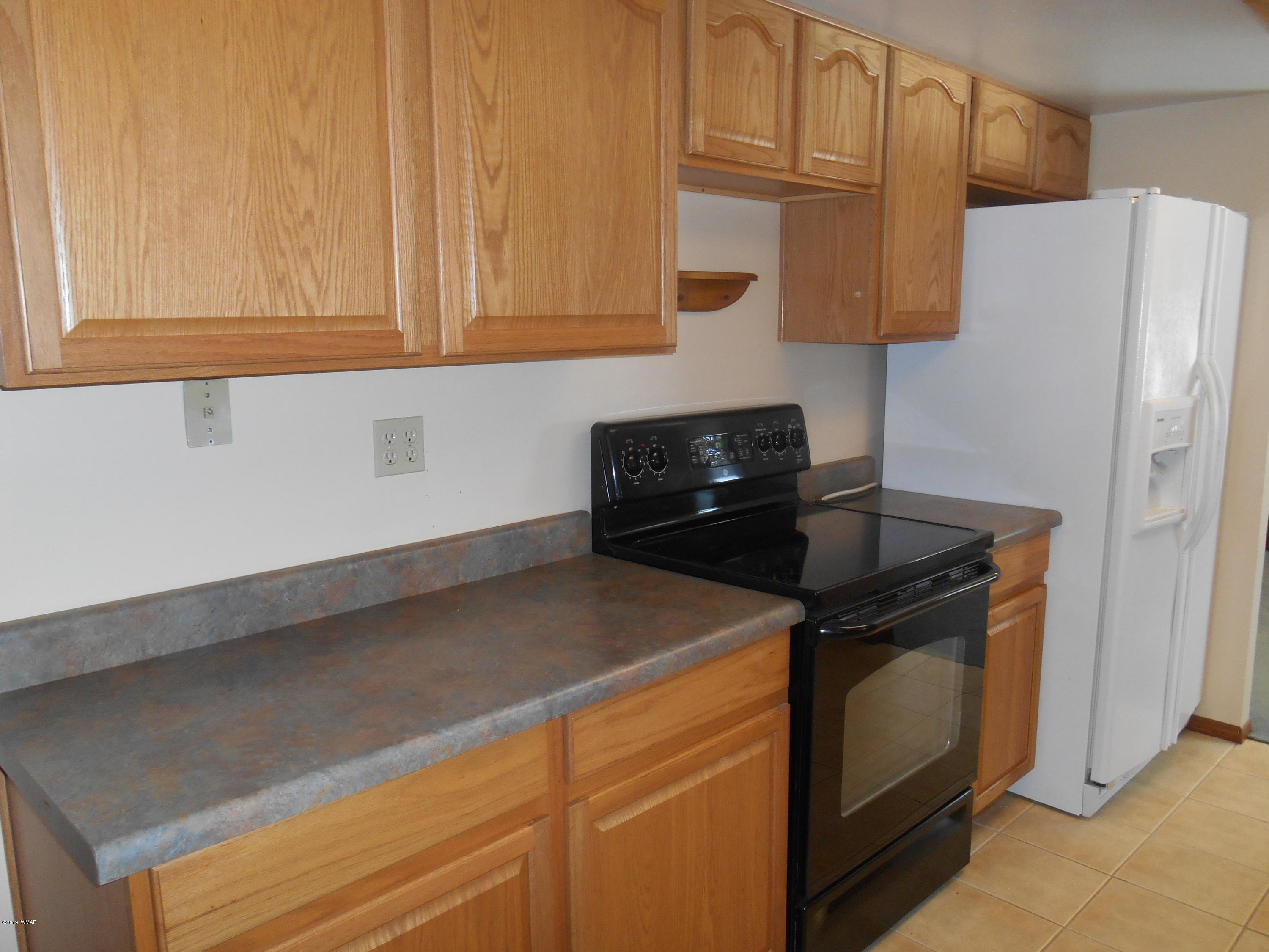 2141 Wildflower Road Overgaard, AZ 85933 - Photo 10 of 21 a kitchen with stainless steel appliances granite countertop white cabinets and a stove