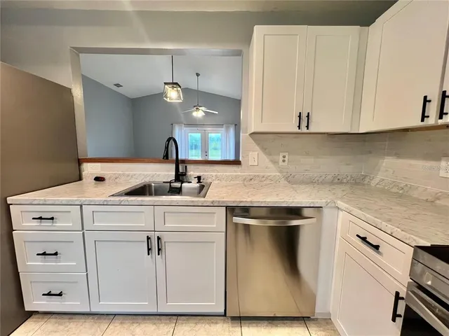 a kitchen with cabinets appliances and a sink