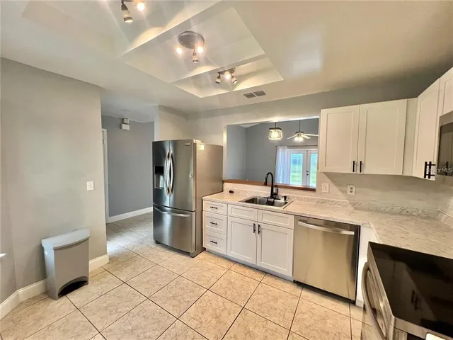 a kitchen with a sink cabinets and stainless steel appliances