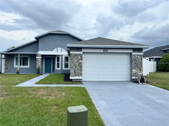 a front view of a house with a yard and garage