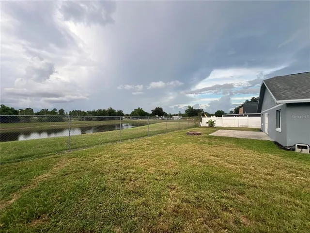 a view of a lake with houses in the back