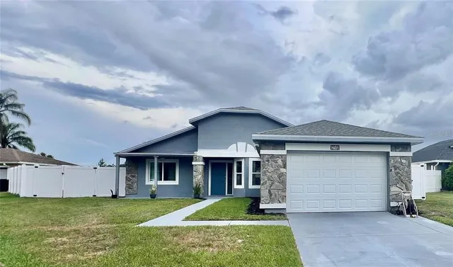 a front view of a house with a yard and garage