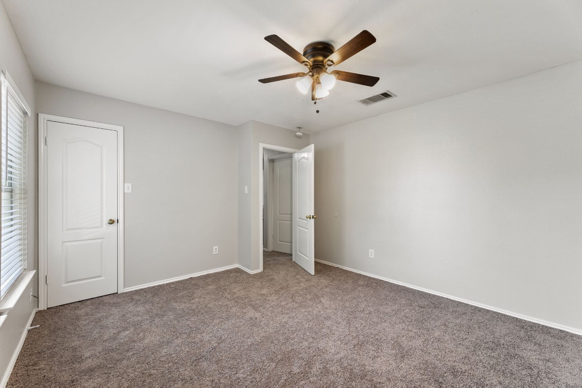 1308 Water Spaniel Way Round Rock, TX 78664 - Photo 11 of 25 an empty room with windows and fan