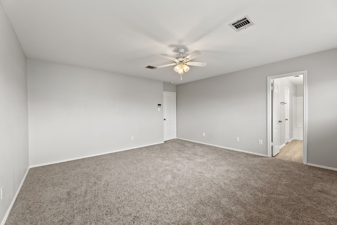 1308 Water Spaniel Way Round Rock, TX 78664 - Photo 16 of 25 an empty room with a ceiling fan and a window