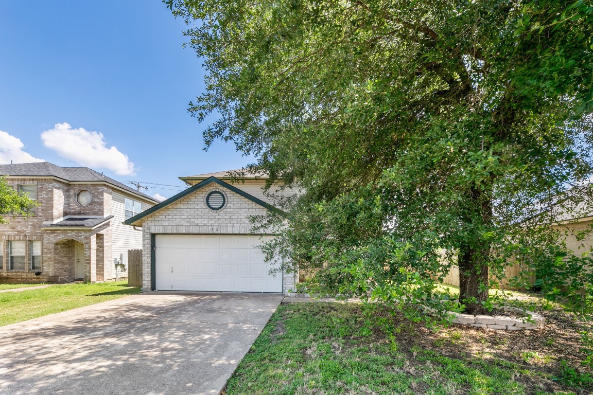 1308 Water Spaniel Way Round Rock, TX 78664 - Photo 25 of 25 a front view of a house with a yard and garage