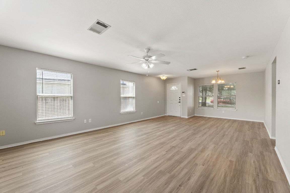 1308 Water Spaniel Way Round Rock, TX 78664 - Photo 3 of 25 a view of an empty room with a window and wooden floor