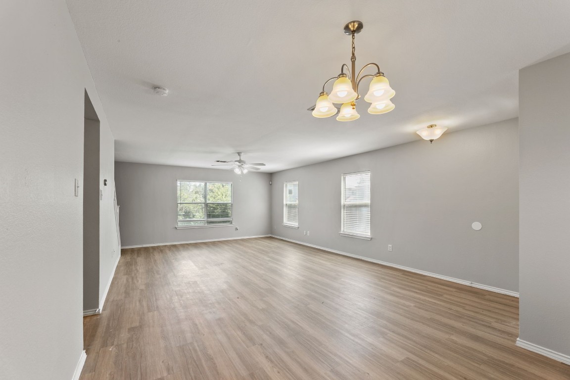 1308 Water Spaniel Way Round Rock, TX 78664 - Photo 5 of 25 a view of an empty room with wooden floor and a window