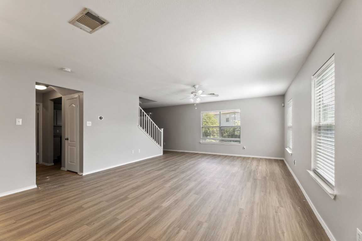 1308 Water Spaniel Way Round Rock, TX 78664 - Photo 6 of 25 an empty room with wooden floor and windows