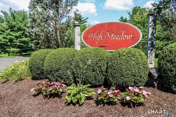 a sign that is in front of flowers