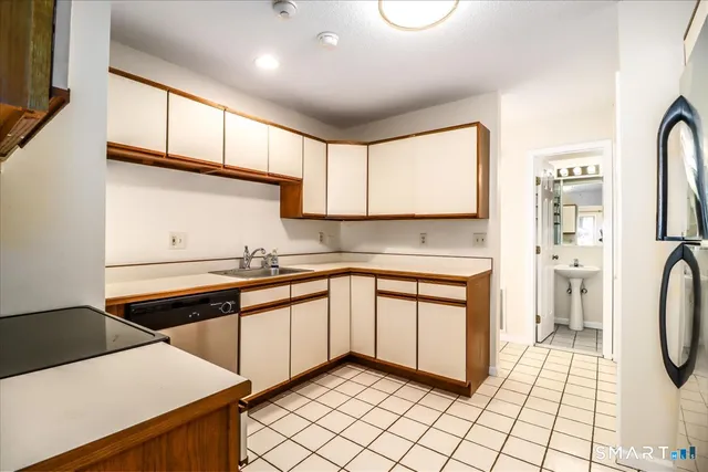 a kitchen with stainless steel appliances granite countertop a sink and cabinets