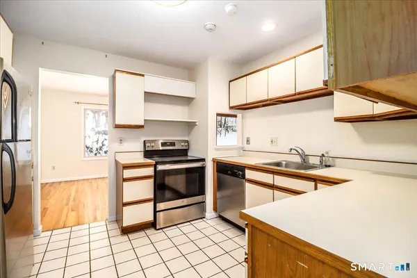a kitchen with stainless steel appliances granite countertop a sink and a stove