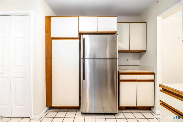 a white refrigerator freezer and a window in a kitchen