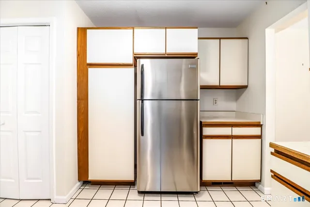 a white refrigerator freezer and a window in a kitchen