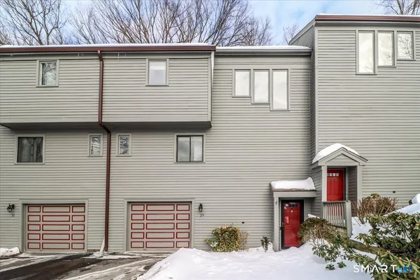 a front view of a house with yard and trees