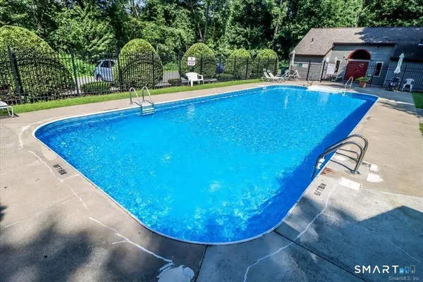 a view of a swimming pool with a yard