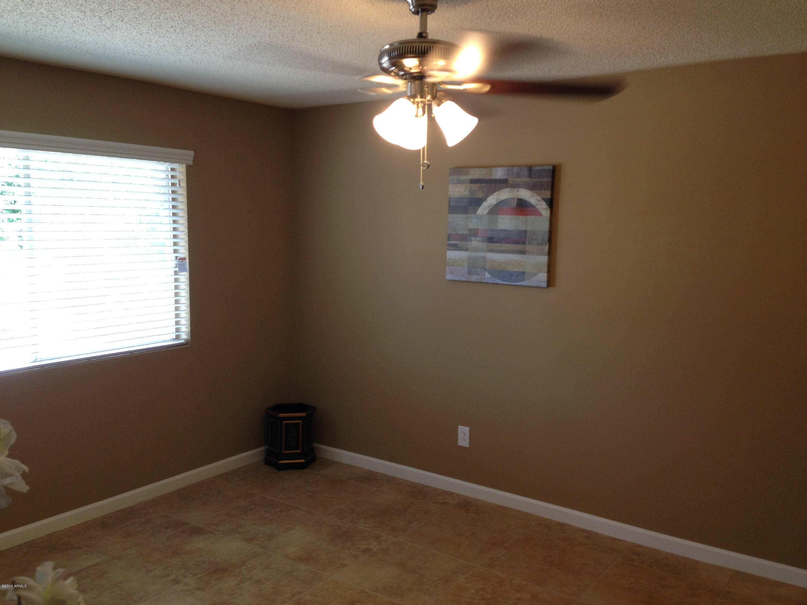 5740 Covina Road Mesa, AZ 85205 - Photo 4 of 19 an empty room with a window