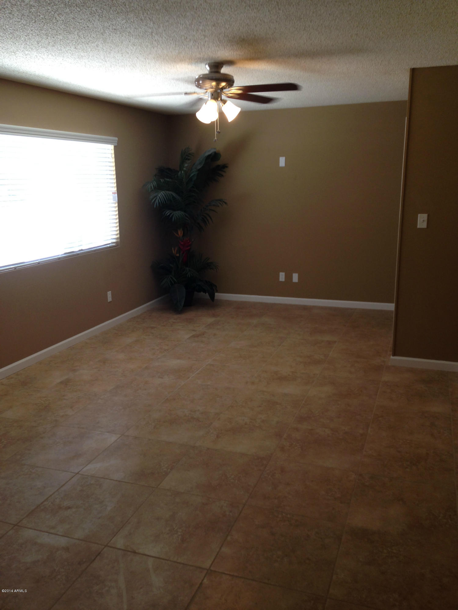 5740 Covina Road Mesa, AZ 85205 - Photo 5 of 19 a view of an empty room with a window