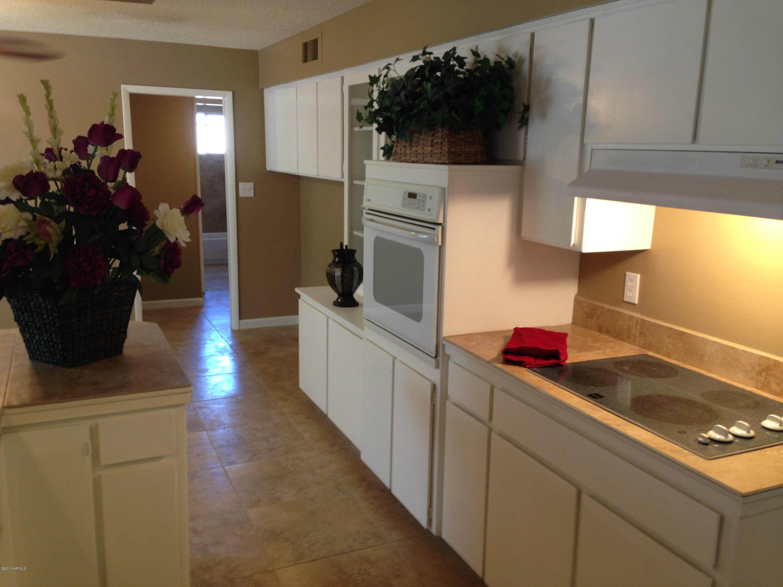 5740 Covina Road Mesa, AZ 85205 - Photo 8 of 19 a kitchen with a sink and a stove top oven