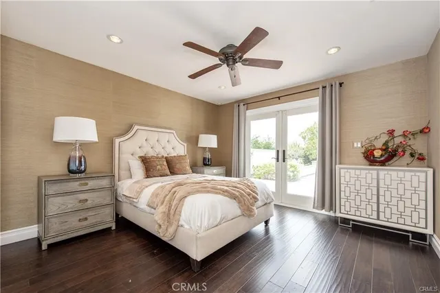 a dining room with wooden floor and large windows
