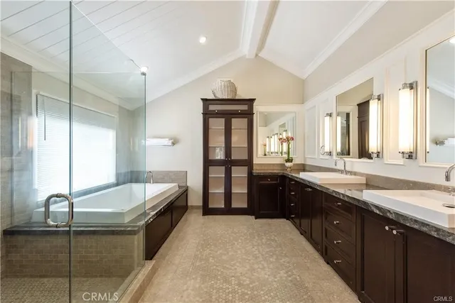 a spacious bedroom with a bed and a flat screen tv