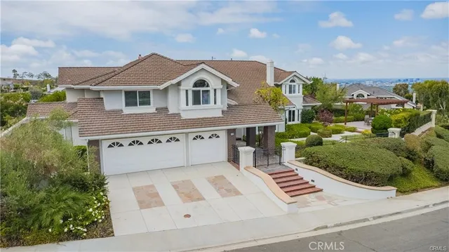 a view of a house with backyard sitting area and garden