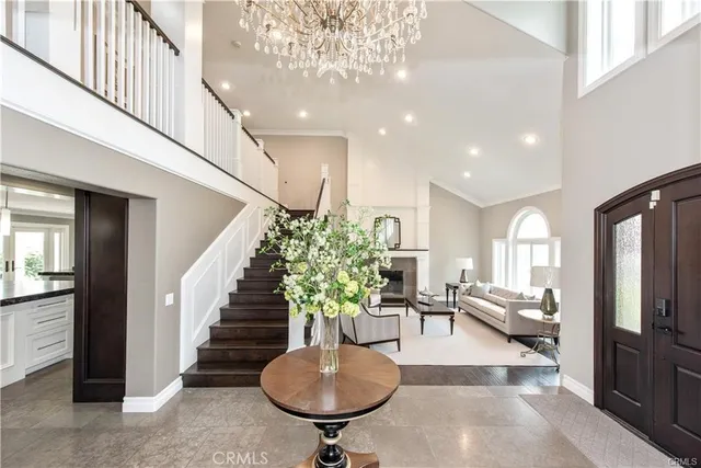 a living room with furniture a fireplace and a large window