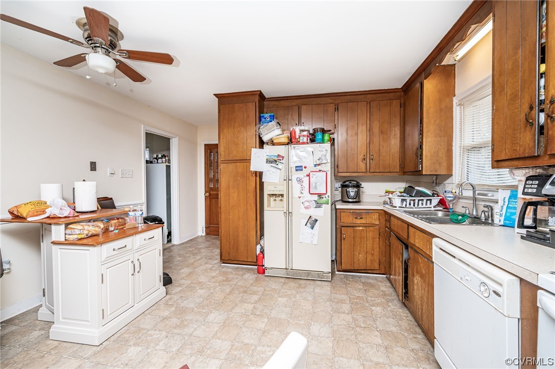 5118 Hackney Road Richmond, VA 23234 - Photo 8 of 17 a kitchen with stainless steel appliances a stove a refrigerator a sink a stove cabinets dining table and chairs