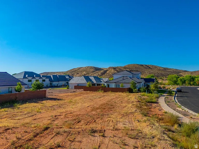 1240 North Gallen Road, Unit 12 Santa Clara, UT 84765 - Photo 19 of 19 Cleared building lot with surrounding residential properties, paved street, and sidewalk