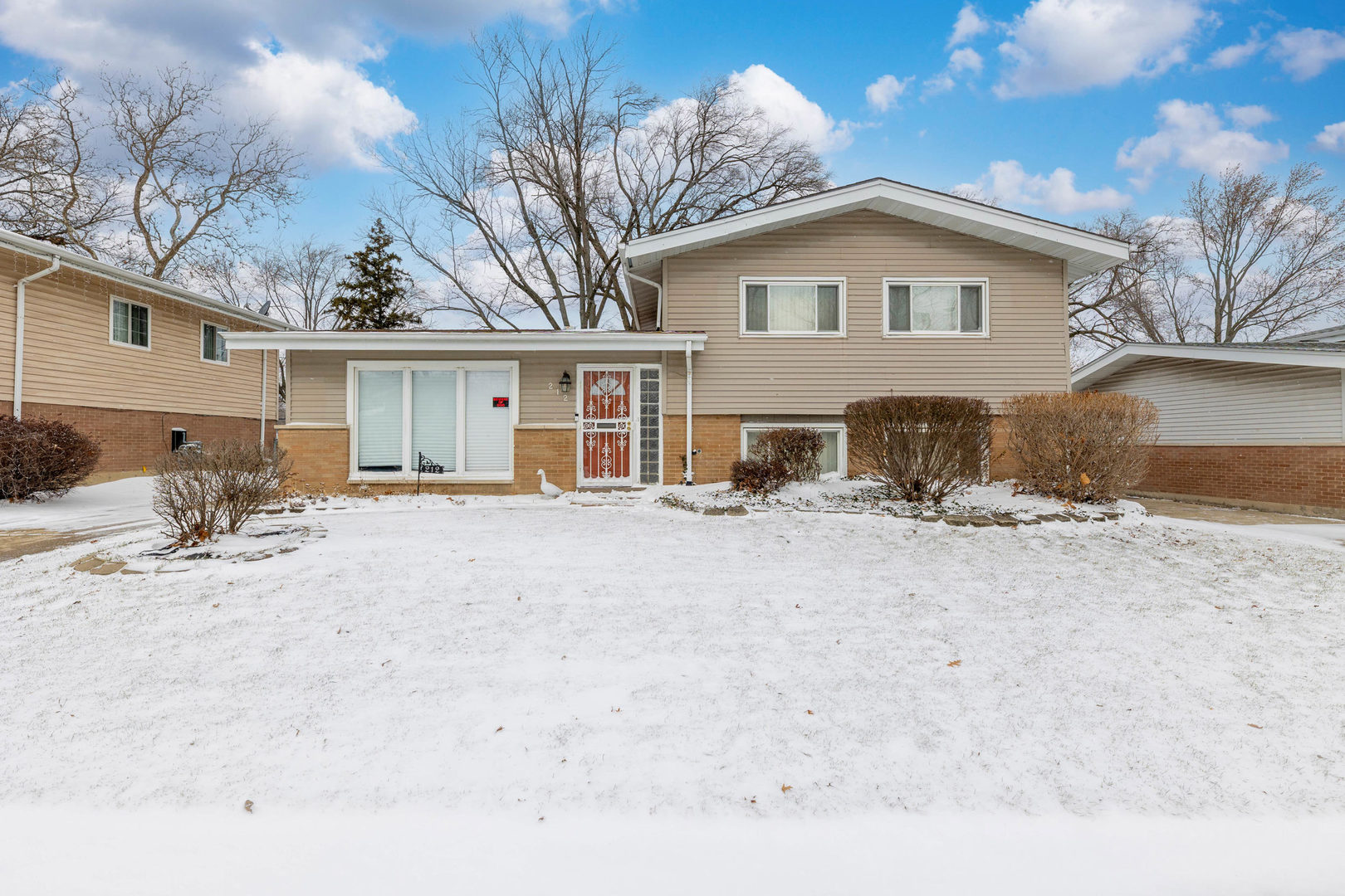 a view of a house with a yard covered in snow