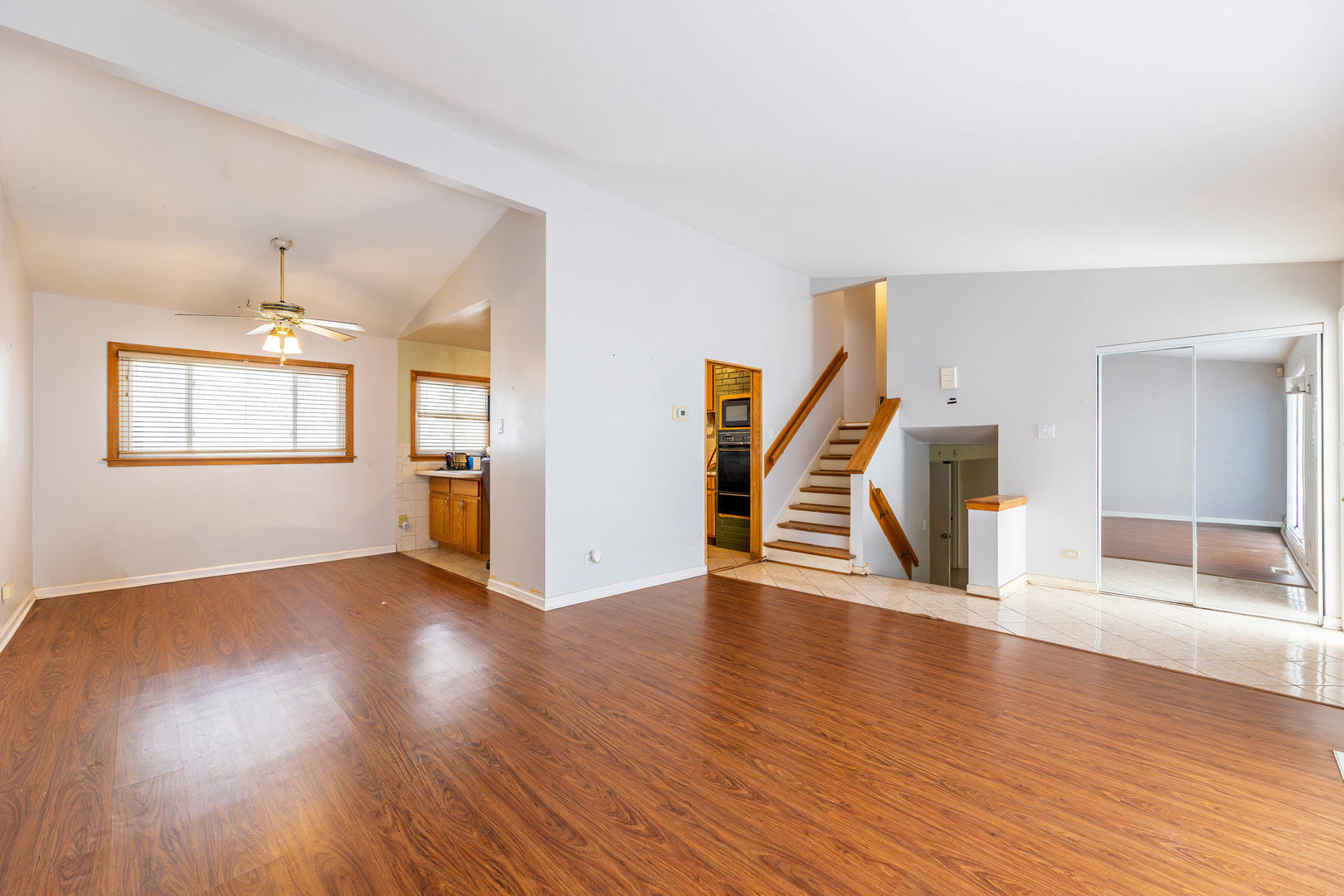 212 Berry Street Park Forest, IL 60466 - Photo 2 of 10 an empty room with wooden floor staircase and windows